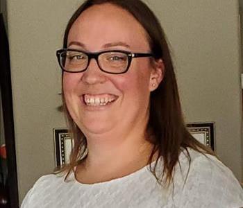  photo of female employee with glasses smiling