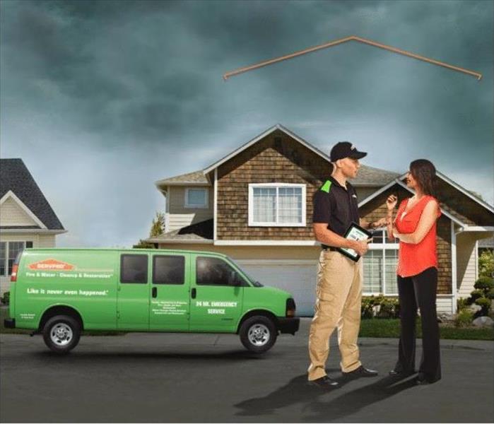 A Picture Of A SERVPRO Employee Helping A Customer At Their Home