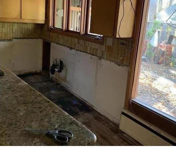 cabinets and baseboards removed from a water damaged kitchen