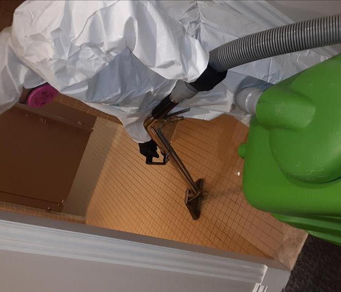 SERVPRO employee extracting flood water in a Woodland Hills office