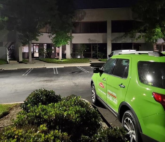 SERVPRO vehicle in front of a building at night