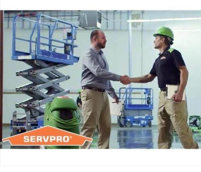 commercial building with SERVPRO employee shaking hands with building manager