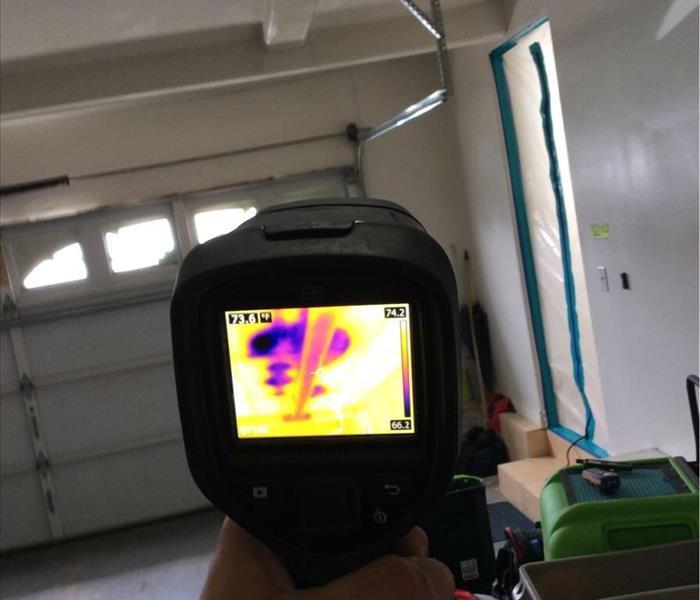 Infrared camera aimed at water damage in garage
