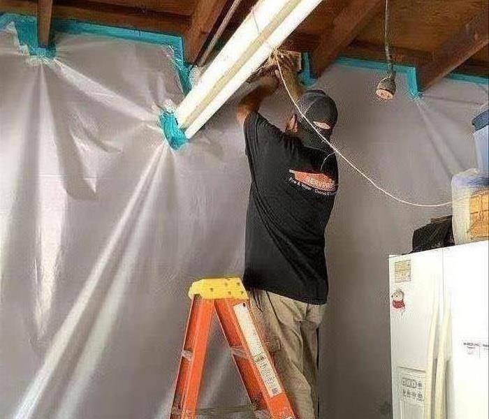 Technician Setting Up Containment