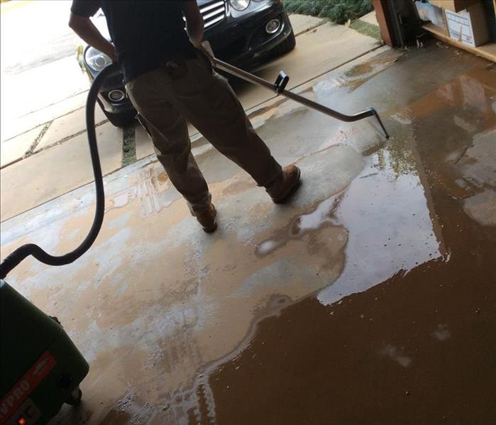 SERVPRO employee extracting flood water